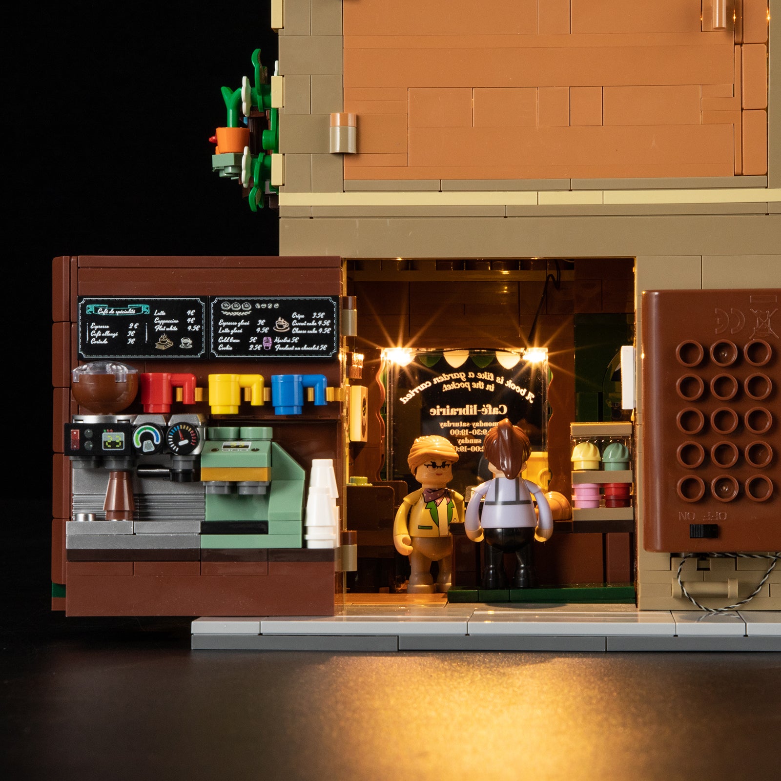 Book Cafe with LED lights illuminated showing warm interior glow through windows and storefront